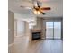 Bright living room features a fireplace, ceiling fan, and sliding glass doors leading to a balcony at 698 S Racetrack Rd # 114, Henderson, NV 89015