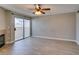 Spacious living room with modern fireplace and sliding glass doors leading to a balcony at 698 S Racetrack Rd # 114, Henderson, NV 89015