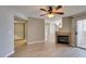 A spacious living room featuring an electric ceiling fan, fireplace, and hardwood floors at 698 S Racetrack Rd # 114, Henderson, NV 89015