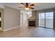 Bright living room features a fireplace, ceiling fan, and sliding glass doors leading to a balcony at 698 S Racetrack Rd # 114, Henderson, NV 89015