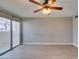 A spacious living room featuring an electric ceiling fan and a sliding glass door at 698 S Racetrack Rd # 114, Henderson, NV 89015