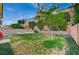 Grassy backyard with mature trees and a pool at 7035 Chestnut Valley St, Las Vegas, NV 89166