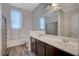 Bathroom with double sinks, wood-look flooring, and decorative gray shower curtain at 7035 Chestnut Valley St, Las Vegas, NV 89166