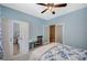 Comfortable bedroom featuring a ceiling fan, a closet, a desk, and a bed with blue floral bedding at 7035 Chestnut Valley St, Las Vegas, NV 89166