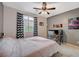 Bedroom featuring a ceiling fan, neutral carpet, and gray accent wall with chevron curtains at 7035 Chestnut Valley St, Las Vegas, NV 89166