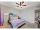 A carpeted bedroom with a decorative headboard, closet, and cozy bedding at 7035 Chestnut Valley St, Las Vegas, NV 89166
