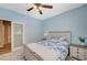 Cozy bedroom features a comfortable bed, a ceiling fan, and sliding glass doors to the backyard at 7035 Chestnut Valley St, Las Vegas, NV 89166