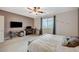 Bedroom with bed, computer desk, ceiling fan, and view of the nearby bathroom at 7035 Chestnut Valley St, Las Vegas, NV 89166