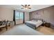 Bedroom featuring a large window, neutral wall paint, a black bed frame, and ceiling fan at 7035 Chestnut Valley St, Las Vegas, NV 89166