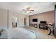 Spacious bedroom with a ceiling fan, desk, TV, and bed, with an ensuite bathroom at 7035 Chestnut Valley St, Las Vegas, NV 89166