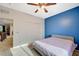Carpeted bedroom featuring a closet, blue accent wall, and neutral decor, creating a serene atmosphere at 7035 Chestnut Valley St, Las Vegas, NV 89166