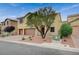 Two-story home featuring a terracotta-colored driveway and two-car garage at 7035 Chestnut Valley St, Las Vegas, NV 89166
