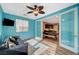 Stylish sunroom with bright teal walls and access to the dining and kitchen at 7035 Chestnut Valley St, Las Vegas, NV 89166