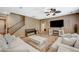 Comfortable living room with a ceiling fan, fireplace, and wood floors at 7035 Chestnut Valley St, Las Vegas, NV 89166
