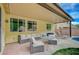 Inviting covered patio with comfortable seating, perfect for outdoor relaxation and entertaining by the pool at 7035 Chestnut Valley St, Las Vegas, NV 89166