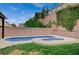 Private in-ground pool and spa surrounded by lush greenery and a brick wall for added privacy at 7035 Chestnut Valley St, Las Vegas, NV 89166