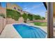 Beautiful backyard featuring a refreshing swimming pool, spa, lush greenery, and privacy fence at 7035 Chestnut Valley St, Las Vegas, NV 89166