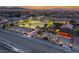 Nevada property featuring a horse arena with lights, covered stalls, and a luxury home during sunset at 728 N Kiel St, Henderson, NV 89015