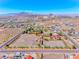 Aerial view shows land, equestrian facilities, desert landscaping, and mountain views at 728 N Kiel St, Henderson, NV 89015