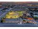 Nevada property featuring a lighted horse arena, stables, inground pool, and beautifully lit landscape at sunset at 728 N Kiel St, Henderson, NV 89015