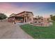 Backyard exterior view with fountain and second story balcony, providing a luxurious outdoor experience at 728 N Kiel St, Henderson, NV 89015