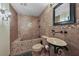 Unique bathroom with earth tone tile, custom vanity, shower and tub at 728 N Kiel St, Henderson, NV 89015