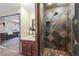 Updated bathroom features a custom tile shower and views to the main bedroom at 728 N Kiel St, Henderson, NV 89015