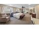 Spacious bedroom with carpet and a comfortable sitting area, perfect for relaxation at 728 N Kiel St, Henderson, NV 89015
