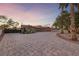 Beautiful desert home with palm trees and a long patterned driveway leading to a garage at 728 N Kiel St, Henderson, NV 89015