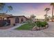 Charming stone house with fountain, elegant landscaping, and a stone-paved driveway at 728 N Kiel St, Henderson, NV 89015