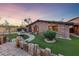 Charming stone house with a beautiful lawn, a fountain, and a pathway at 728 N Kiel St, Henderson, NV 89015
