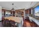 An expansive kitchen features stainless steel appliances, a stone oven arch and an island with bar stool seating at 728 N Kiel St, Henderson, NV 89015