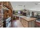 Kitchen area with a long island and stone arches above cooking area at 728 N Kiel St, Henderson, NV 89015