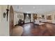 Living room with stone fireplace, hardwood floors, natural light, and a decorative arched doorway at 728 N Kiel St, Henderson, NV 89015