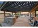 Exterior features a swimming pool, spa, outdoor kitchen and covered entertaining area at 728 N Kiel St, Henderson, NV 89015