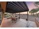Covered patio with outdoor seating overlooks the horse property, creating a relaxing entertaining space at 728 N Kiel St, Henderson, NV 89015