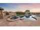Backyard features a swimming pool and spa with outdoor cooking and entertaining space at 728 N Kiel St, Henderson, NV 89015
