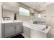 A luxurious bathroom with a soaking tub, double vanity, and a glass-enclosed shower at 731 Glowing Horizon St, Henderson, NV 89052