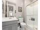 Well-lit bathroom with a glass-door shower, gray vanity, and modern fixtures at 731 Glowing Horizon St, Henderson, NV 89052