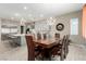 Dining area with modern lighting, a large wood table and seating for up to eight people at 731 Glowing Horizon St, Henderson, NV 89052