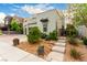 Charming two-story home with landscaped yard, gravel accents and sidewalk path to the front door at 731 Glowing Horizon St, Henderson, NV 89052