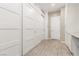 Bright hallway features wood-look flooring, large storage closets, and access to the front door at 731 Glowing Horizon St, Henderson, NV 89052