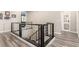 Hallway with modern railing leading to the stairs and view of the gray-toned bathroom at 731 Glowing Horizon St, Henderson, NV 89052