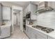 Kitchen with stainless appliances, quartz countertops, gray cabinets, and a custom backsplash at 731 Glowing Horizon St, Henderson, NV 89052