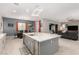 Open kitchen with a large island with barstool seating and views to living and dining spaces at 731 Glowing Horizon St, Henderson, NV 89052