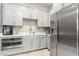 Kitchenette featuring grey cabinets, stainless steel refrigerator, oven, and sink at 731 Glowing Horizon St, Henderson, NV 89052