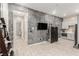 Living room with adjacent wet bar and exercise equipment with marble accent wall at 731 Glowing Horizon St, Henderson, NV 89052