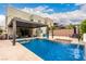 Backyard pool with patio furniture, swings, and a spiral staircase to the second floor at 731 Glowing Horizon St, Henderson, NV 89052