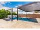 Backyard pool featuring a covered pergola, spa, waterfall feature, and mature trees at 731 Glowing Horizon St, Henderson, NV 89052