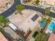 Aerial view of a tan home featuring a tile roof, pool, and solar panels at 7401 Bridlehorne Ave, Las Vegas, NV 89131